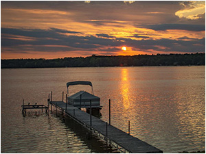 Shimmering Shores (link) picture shows lake at sunset with pier and pontoon boat.