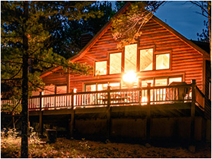 Whispering Pines Lakeside Lodge (link) picture show a long pier with bench stretching out over the water of the lake.